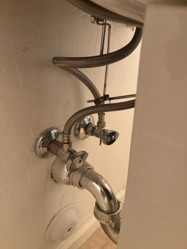 New quarter-turn shut-off valves and braided supply lines under a bathroom sink