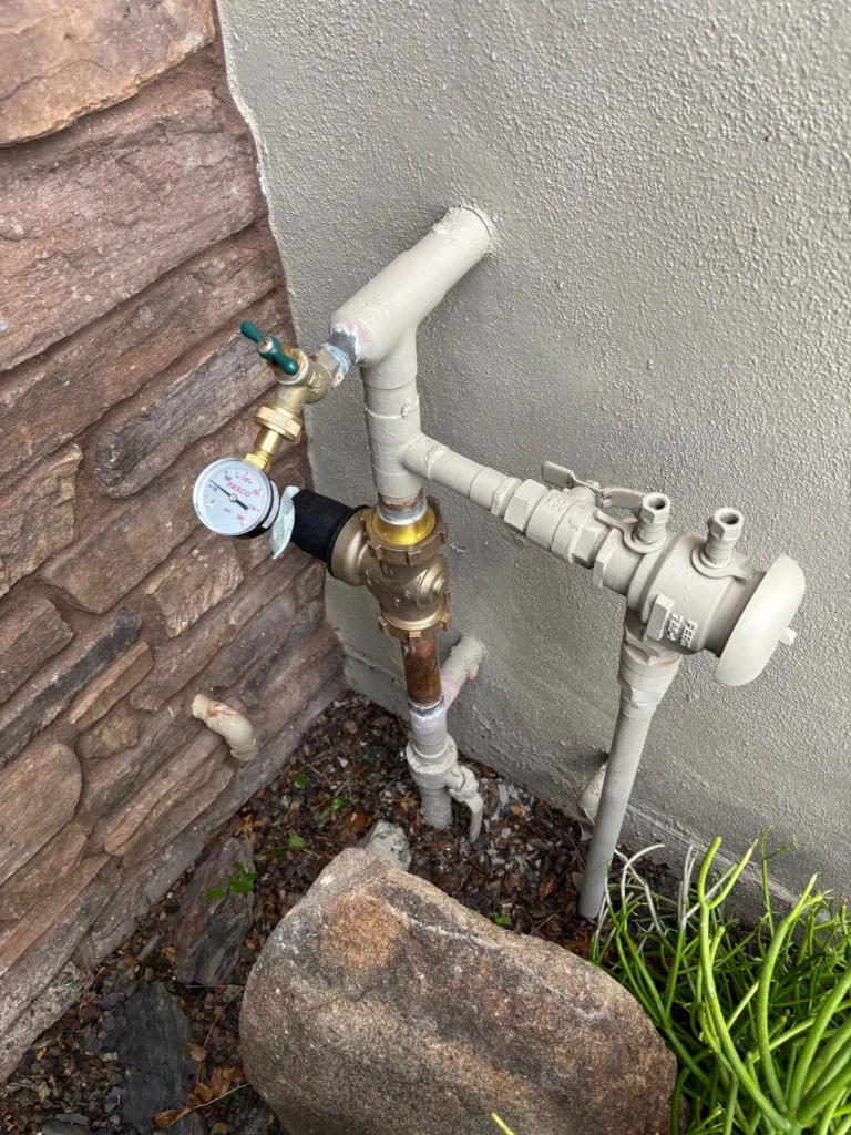 New brass pressure regulator installed on the main water line