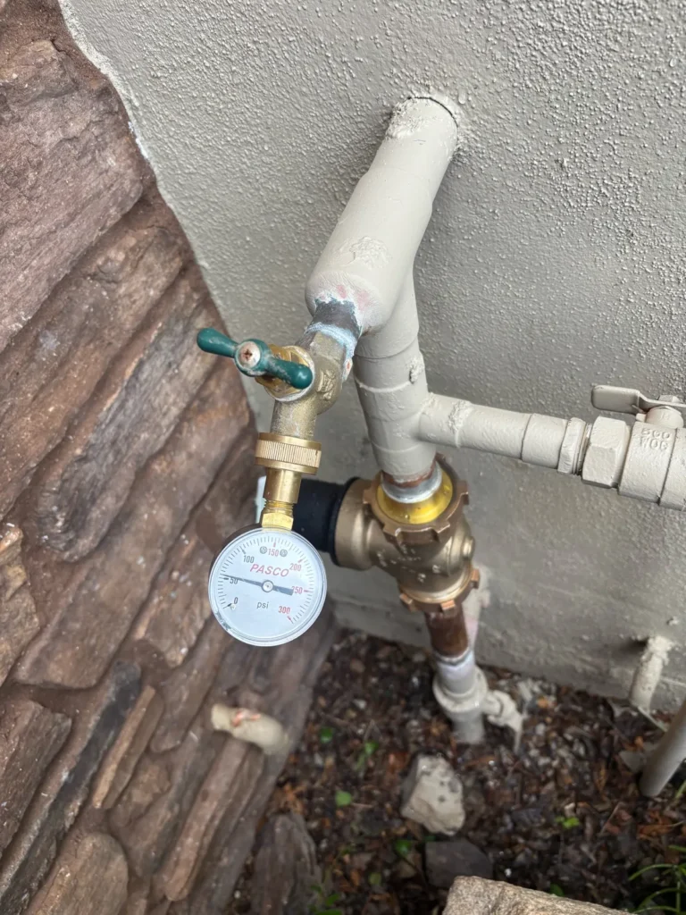 Water pressure checked with a gauge after a plumbing repair that installed a new pressure regulator